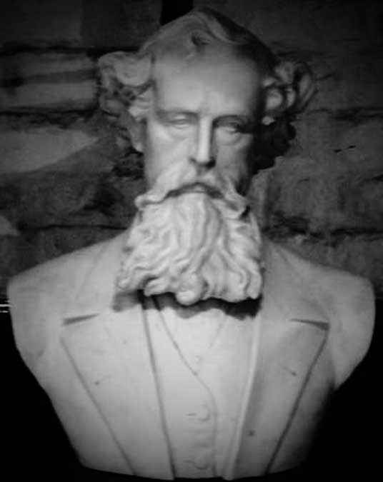 A white marble bust of Charles Dickens.